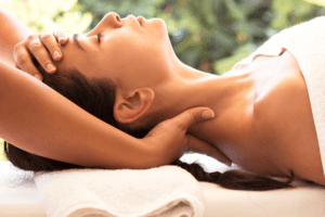 A woman receiving massage therapy for its health benefits