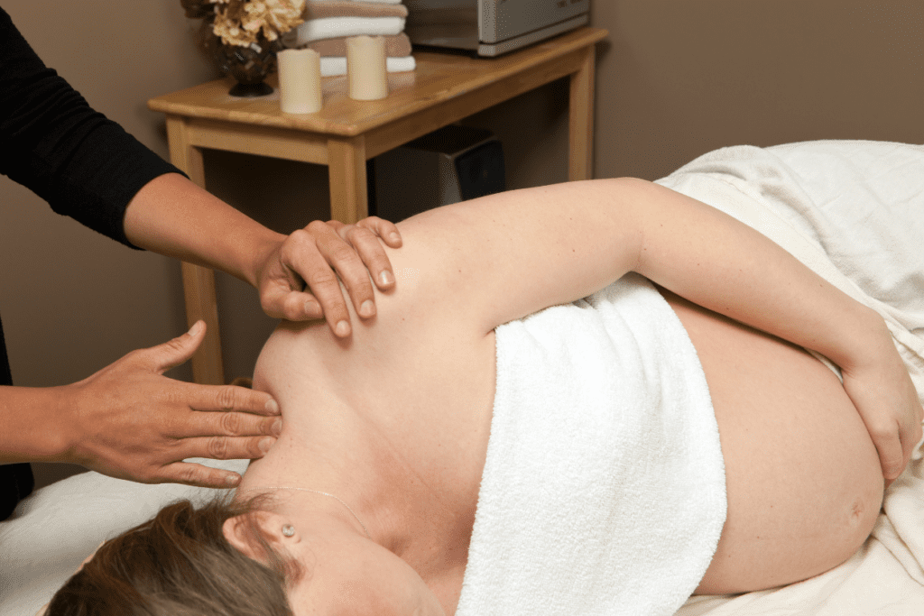 Expecting mother at the spa getting prenatal massage to experience the wonderful benefits of prenatal massage.