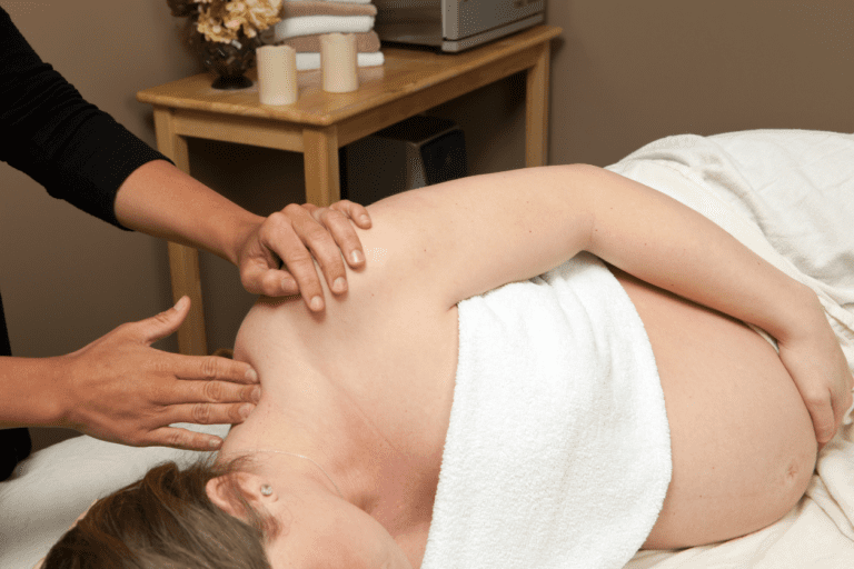 Expecting mother at the spa getting prenatal massage to experience the wonderful benefits of prenatal massage.