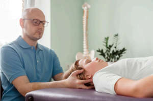 A therapist is helping a young girl with headaches