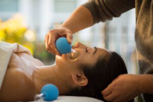 Facial Rejuvenation- Woman having a facial cupping massage to stimulate blood circulation