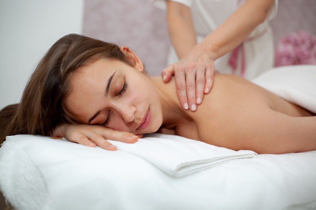 Pretty young woman relaxing and enjoying the benefits of therapeutic massage at the spa