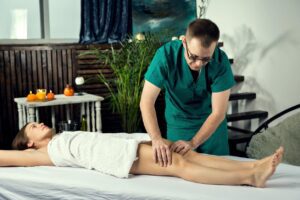 A massage therapist gives a post-op lymphatic drainage massage to a young girl to relieve pain and boost her immune system.
